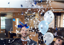 Photo of a man surrounded by confetti.