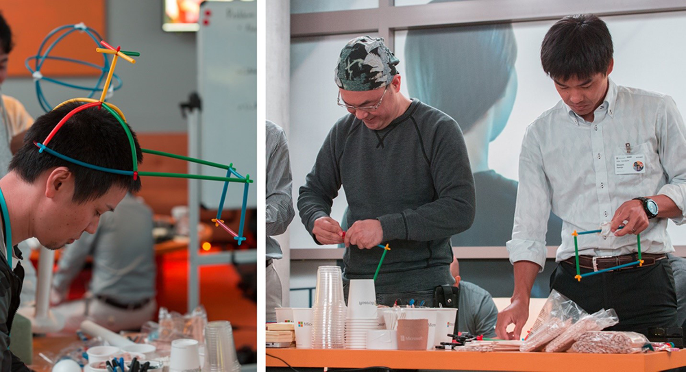 Photograph of a design team prototyping mixed-reality interactions and features with crafting materials.