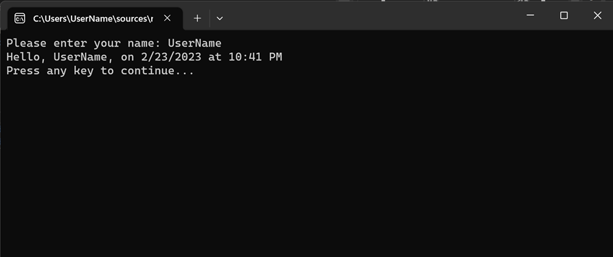 Capture d’écran montrant la fenêtre de console de débogage avec « Entrez votre nom », la date et l’heure, et « Appuyez sur n’importe quelle touche pour continuer ».